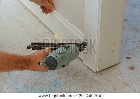 Gauge Finish Nailer man nailed slats custom house building contractor up a wall section for luxury custom house