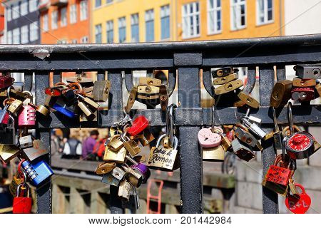 Copenhagen Denmark - August 24 2017: In the handrail at the bridge Nyhavnsbroen in Nyhavn there are locked padlocks as a symbol of love.