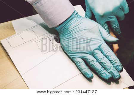 The investigator takes fingerprints from the suspect in the crime. Investigation is a crime.