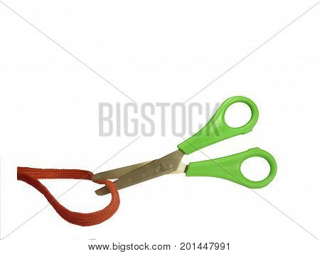 Scissors cut red ribbon isolated on white background