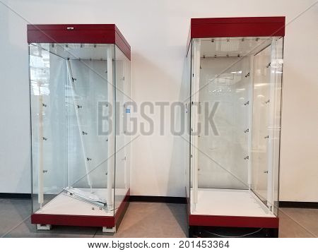 two empty red and glass display cases side by side