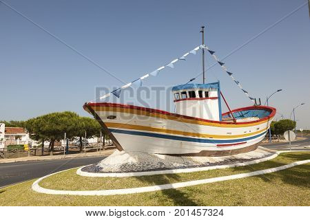 Colorful old fishing boat in the roundabout of town Matalascanas Andalusia Spain