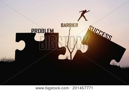 man jumping over jigsaw opposite success shore concept as can solve problem barrier belive and faith to conncet business