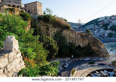 ULCINJ, MONTENEGRO - AUGUST 1, 2017: The wall of Stari Grad - old town of Ulcinj, Montenegro. City and central beach Mala Plaza on background.