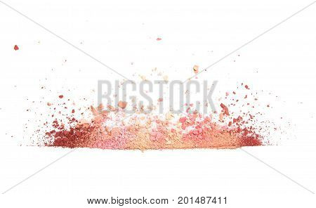 Samples of dry blush, powder, bronzers and highlighter scattered in line isolated on white background