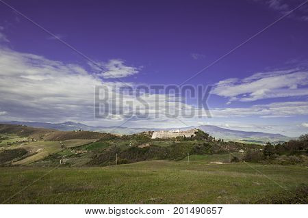 Village Trevinano located upon a hill near the borders of Lazio with the Tuscany and Umbria. Italian landscape with forests and meadow early in the morning. Agriculture in Italy fields and pastures.