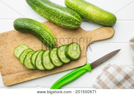 Sliced green cucumbers. Cucumbers on cutting board. Top view.