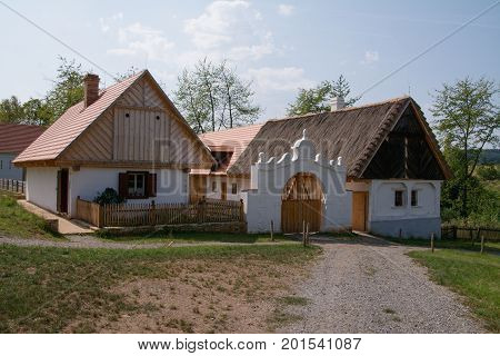 Rural homestead with saddle roof, farmyard and original decorative gate from the 19th century. Open Air Museum in Kourim Czech Republic