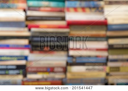 A stack of books with colorful covers. The library or bookstore. Books or textbooks. Education and reading. Unfocused image.