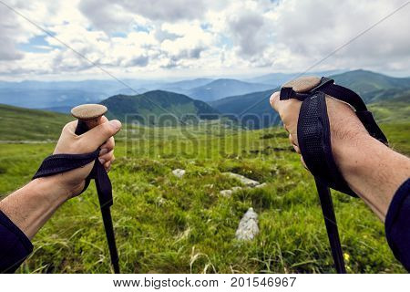 Hiking in the mountains with a backpack in the summer.