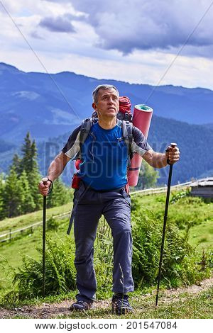 Hiking in the mountains with a backpack in the summer.