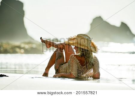young woman relaxing on the beach in summer day