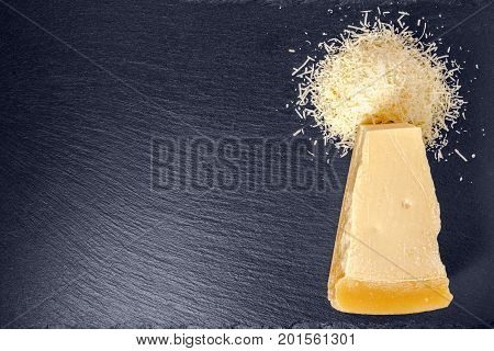 Flat Lay Of Tasty Fresh Yellow Big Segment Piece Hard Parm And Finely Grated Cheese On Stone Slate B