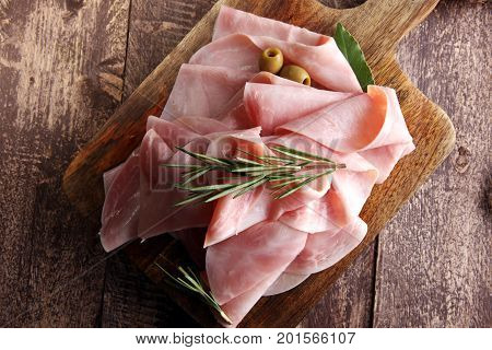 Sliced Ham On Wooden Background. Fresh Prosciutto. Pork Ham Sliced.