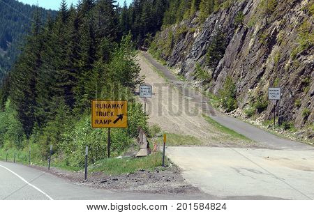 Runaway truck ramp in the forest on a mountain road, designed to slow down a vehicle and help prevent accidents if a commercial truck loses braking or loses control down a steep hill.