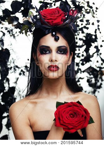 pretty brunette woman with rose jewelry, black and red, bright make up kike a vampire closeup red lips, halloween concept