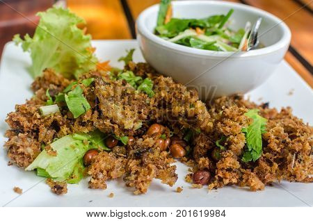 The Best Thai Food. Crispy catfish salad with green mango. Minced Catfish Spicy Salad with Herbs. Exploded catfish salad