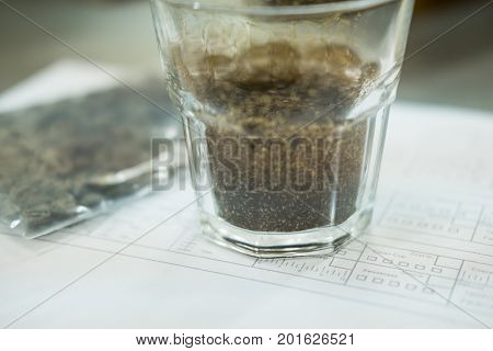 Glass Of Coffee For Taster To Smell And Taste Aromatic And Flavor Wheel. Aroma Perception In Brewed
