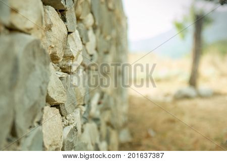 Old vintage stone wal with perspective view and blurred background. Selective focus