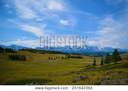 Landscape of snow peaks of North-Chiyski ridge and Kurai steppe in Altai mountains. Republic of Altay Republic Russia.