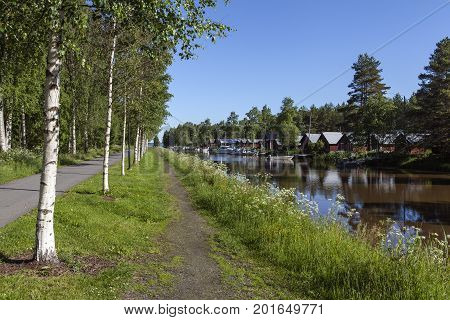 KOKKOLA, FINLAND ON JULY 07. View of a channel, marina by seaside. A walk this side on July 07, 2017 in Kokkola, Finland. Morning and bright sunshine. Flowers and birches. Editorial use.