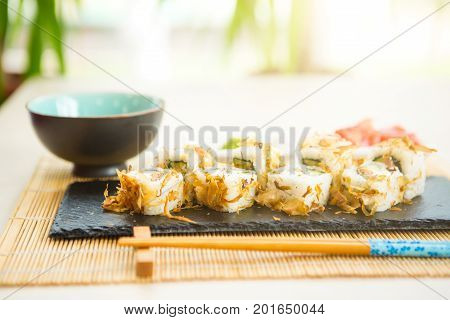 Sushi Rolls On Black Slate Surface. Japanese Food. Hot Fried Sushi Roll