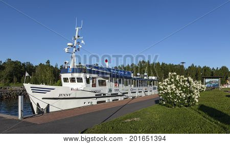 KOKKOLA, FINLAND ON JULY 07. View of Jenny moored by the port on July 07, 2017 in Kokkola, Finland. Channel, sidewalk and bushes in the surrounding. Editorial use.