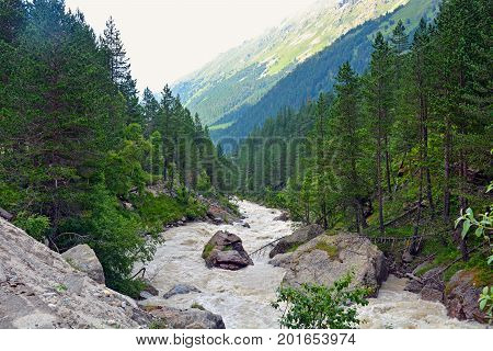 River and waterfall in forest, mountains of Caucasus, Russia.