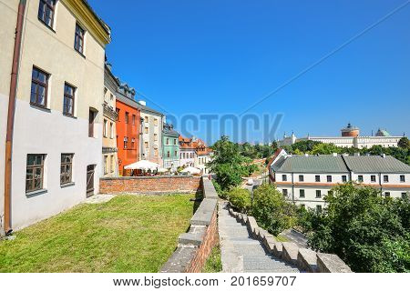 Lublin, Poland - August 10, 2017: Beautiful street and old bright buildings in the old town of center Lublin, Poland. Cityscape and bright blue sky in Lublin, Poland