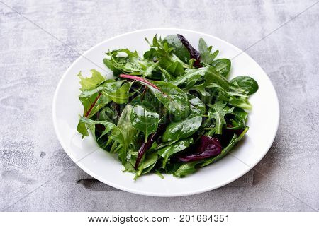 Salad with mixed leaves of arugula mesclun spinach. Healthy vegetarian food.