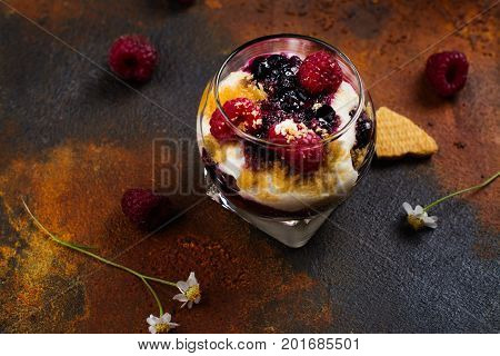 Homemade dessert in glass jars. Cheesecake, trifle, mouse on grunge stone background. Copy space