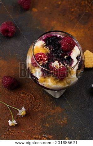 Homemade dessert in glass jars. Cheesecake, trifle, mouse on grunge stone background. Copy space