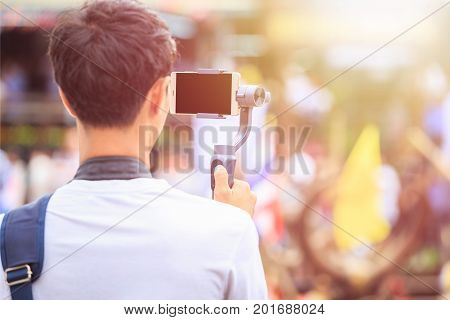 Man Using Modern Smartphone Record Video. Outdoor Setup And Working