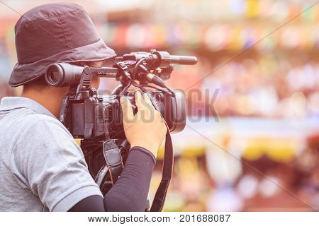 Cameraman Using Professional Digital Video Camera. Outdoor Setup And Working