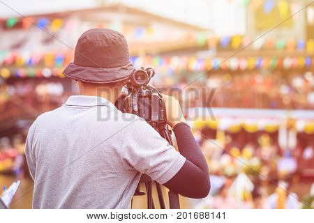 Cameraman Using Professional Digital Video Camera. Outdoor Setup And Working