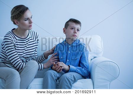 Sick Son Sitting On Sofa