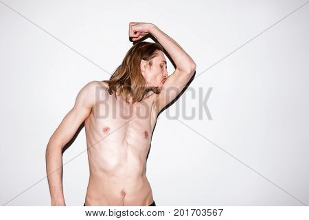 Adult man showing off his muscles. Self-satisfied male, sports guy bragging about courage, power and sport success concept