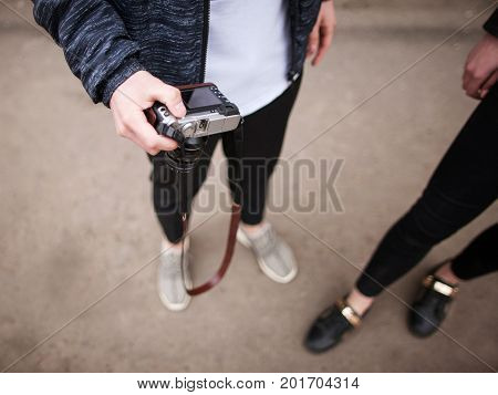 Street photo shoot. Photographers in process. Unrecognizable stylish young people in selective focus, creative lifestyle top view. Modern electronics