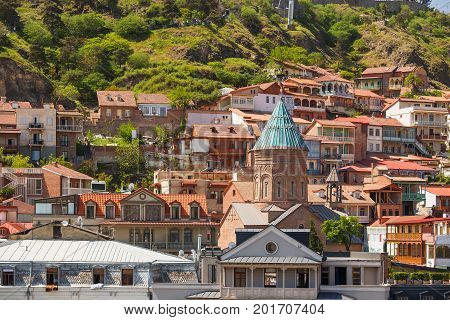 Tbilisi old part of town with cafe little restaurants cobbled pavement and antique buildings. The Cathedral of Saint George (Surb Gevorg) 13th-century Armenian church in the historical quarter of Tbilisi. Georgia.