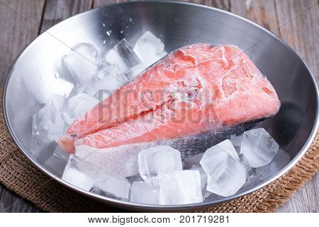 One slice of fish on ice red fish - salmon