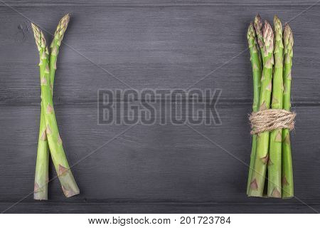 Bunch of fresh asparagus on wooden rustic background. Copy space