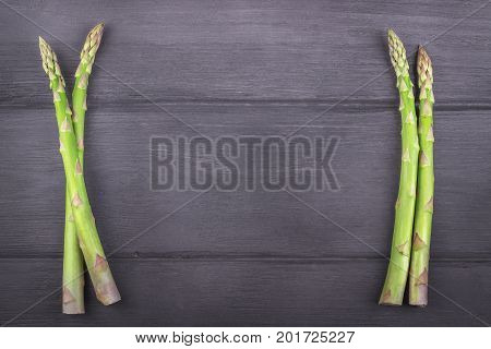 Fresh asparagus on wooden rustic background. Copy space