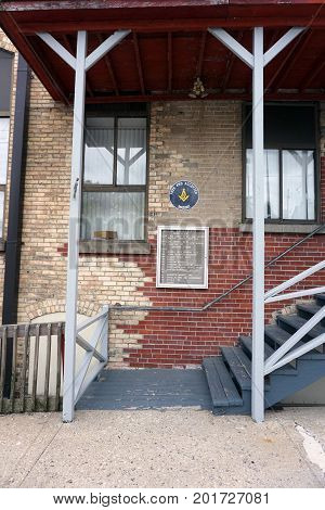 CADILLAC, MICHIGAN / UNITED STATES - MAY 31, 2017: 
A stairway leads to the Cadillac Masonic Center, and various businesses. through the back entrance of an historic brick building, in downtown Cadillac.