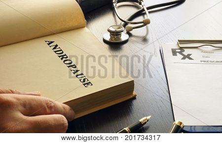 Andropause written in a book. Male Menopause or Manopause concept.