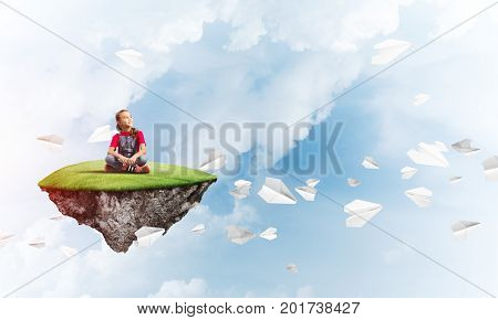 Cute smiling girl on floating island and paper planes flying around