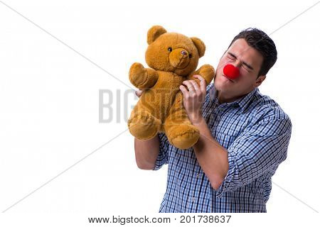 Funny clown man with a soft teddy bear toy isolated on white bac