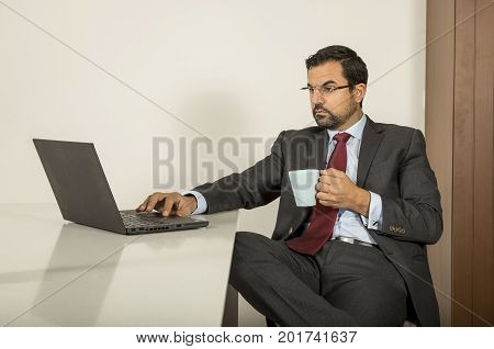 Arab Man Woking In His Laptop In The Kitchen