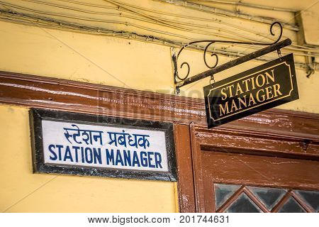 Train station manager sign at Darjeeling, India.