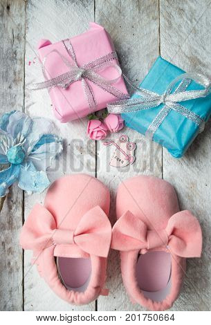 Close up of baby shoes on a wood background. Greeting card