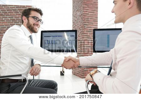 handshake financial partners sitting at Desk